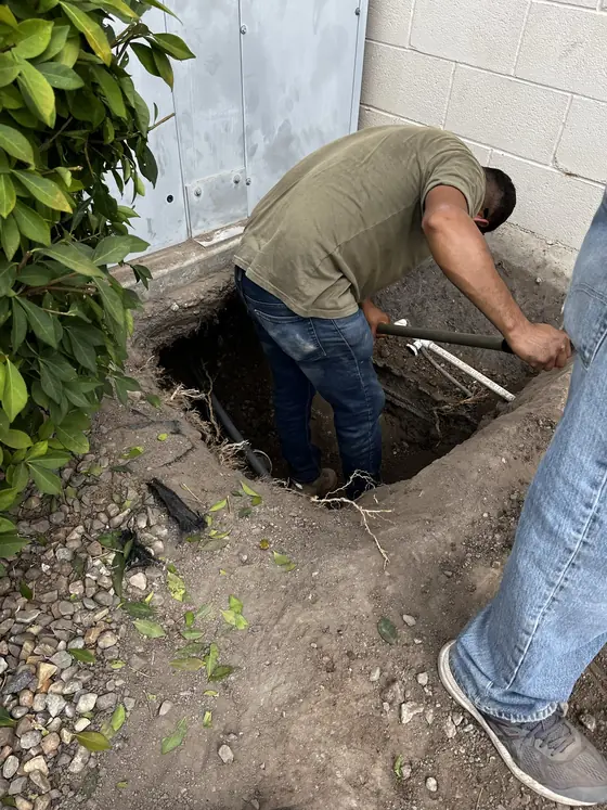 Excavated ground with an exposed underground line