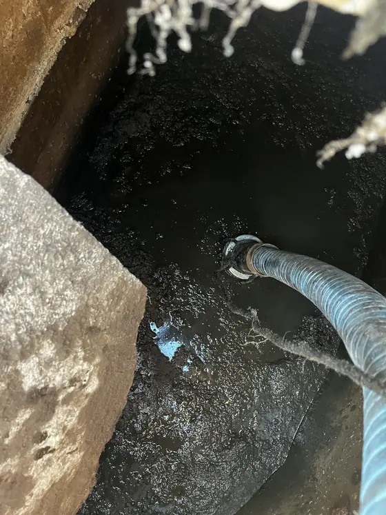Act Now Pros technician beside an open outdoor service access