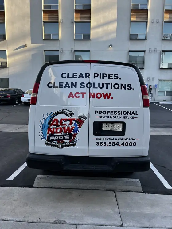Act Now Pros technician beside an open outdoor service access