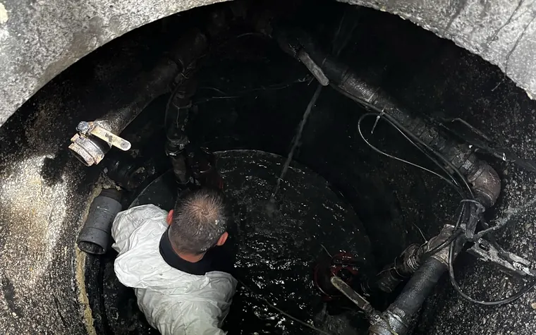 Technician working inside a pump chamber