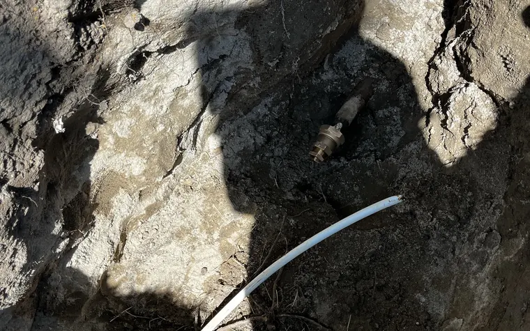 Exposed sewer line in an open excavation